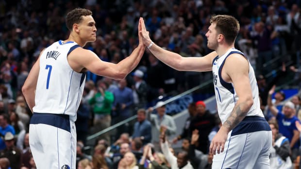 Dallas Mavs' Dwight Powell and Luka Doncic share a high five against the Los Angeles Clippers.